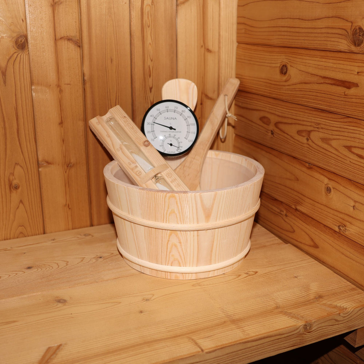 a bucket full of sauna accessories