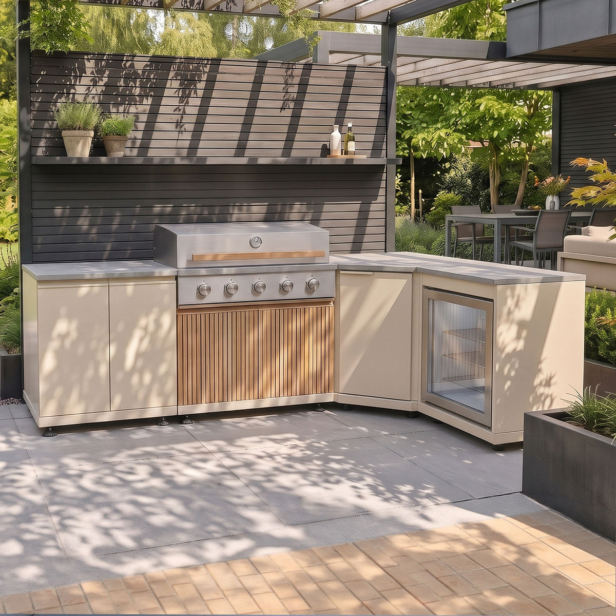Skogen Small Corner Outdoor Kitchen with Fridge in Latte, set out in an L shape on a garden patio