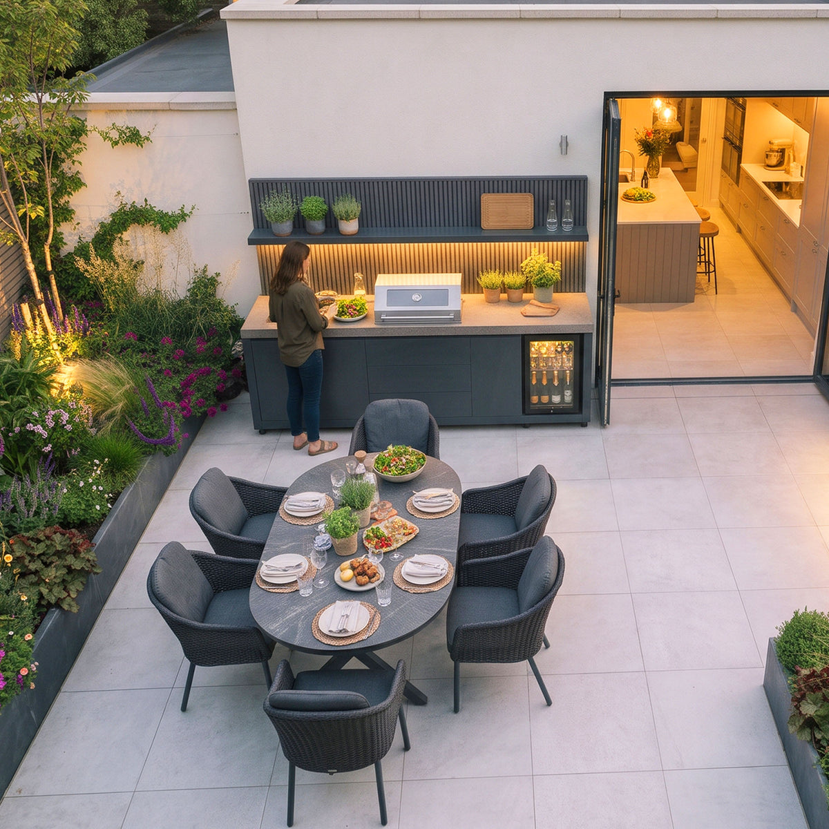Waltons Strata Signature Outdoor Kitchen in Grey from above with a dining table laid for six