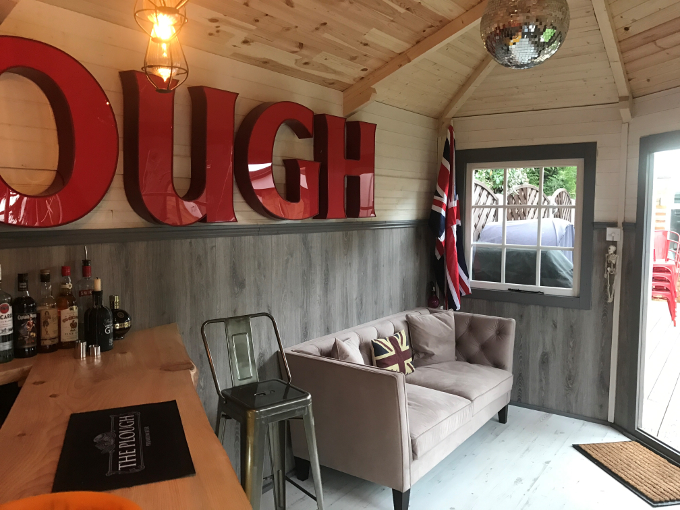 Grey sofa in garden log cabin Grey sofa in garden log cabin