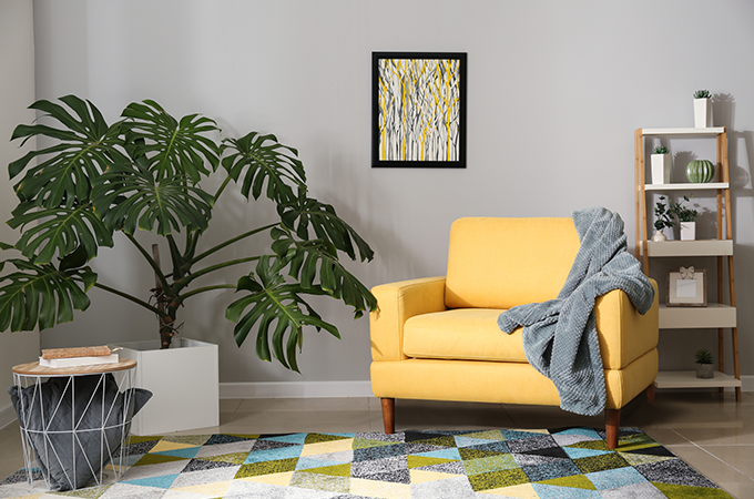 yellow armchair in office with grey blanket yellow armchair in office with grey blanket