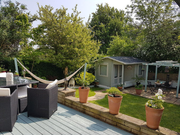 Garden overview with Waltons log cabin in corner Garden overview with Waltons log cabin in corner