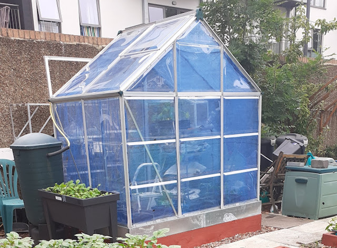 Blue greenhouse with interior shades Blue greenhouse with interior shades