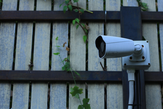 Camera mounted on a fence Camera mounted on a fence