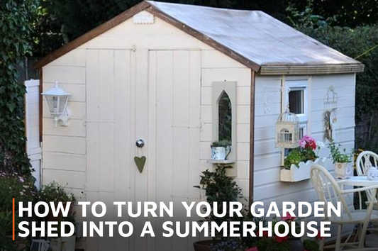 Painted white summerhouse with table and chairs