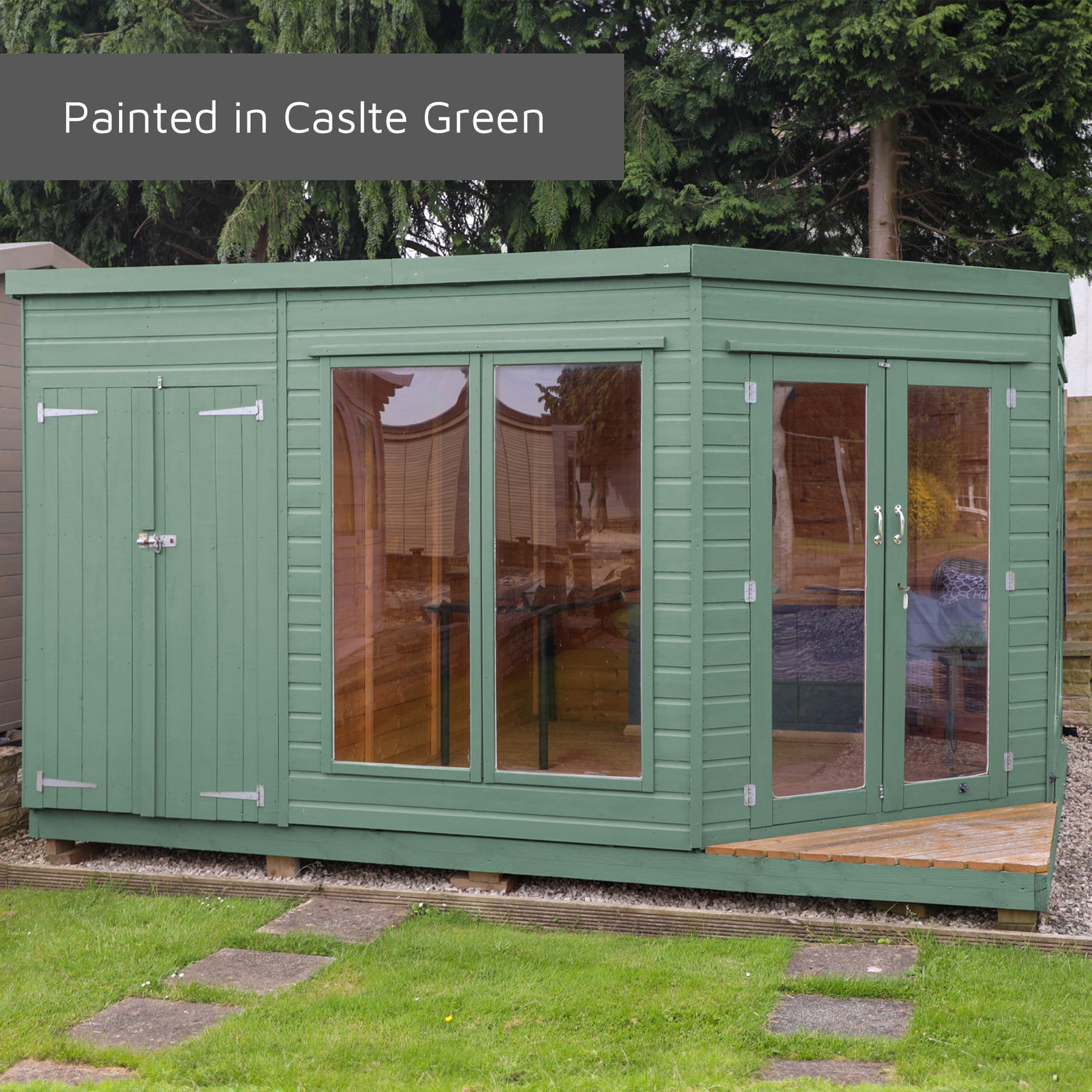 A timber summerhouse with full length windows painted in a green colour