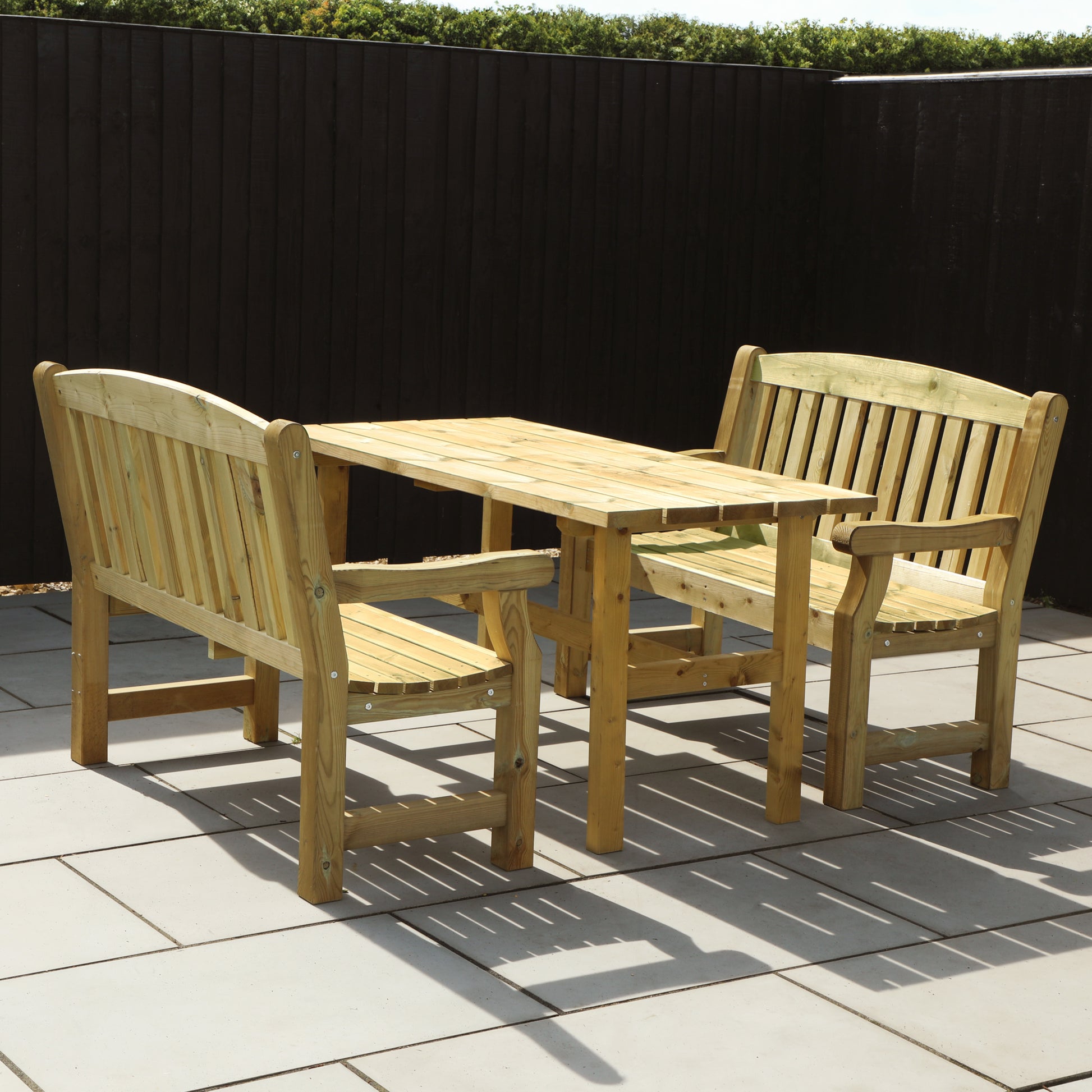 A picture of a timber bench and table set, featuring two benches and a wooden table