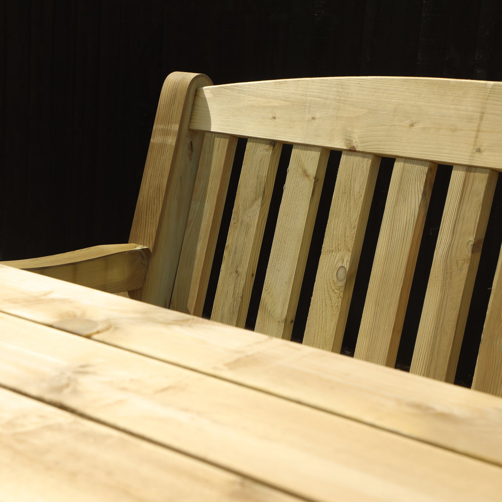 A picture of a timber bench and table set, featuring two benches and a wooden table