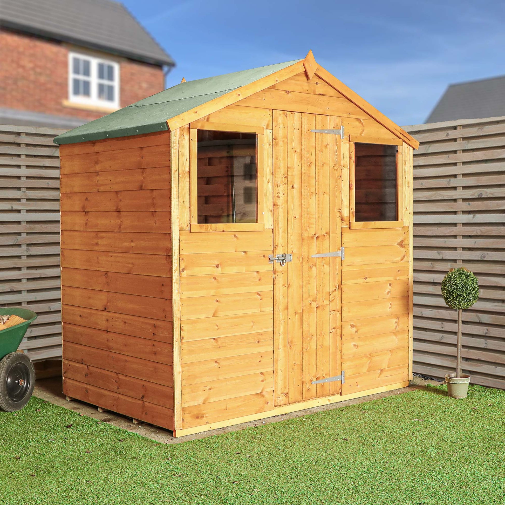 A timber shed with single door and two windows