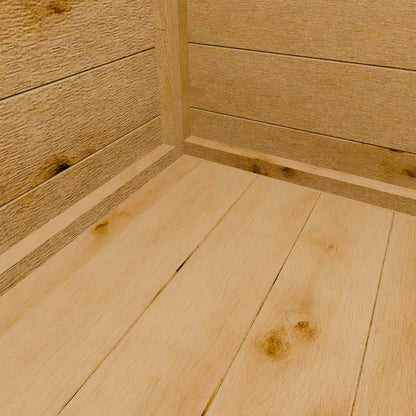 Close-up of wooden shed flooring with a focus on texture and grain.