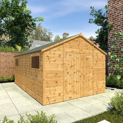 A large timber workshop with double doors, apex roof and windows