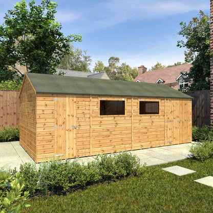 A large workshop with three doors, windows and felt roof, made from timber