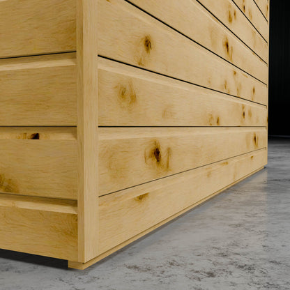 The cladding of a shiplap summer house in a dark setting.