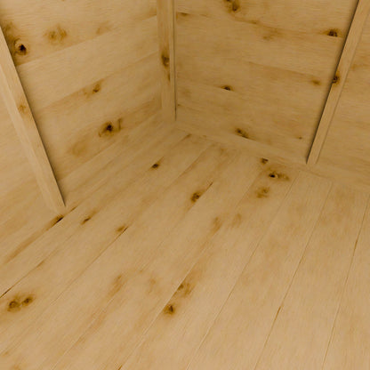 Close-up of a wooden shed floor with visible grain and knots