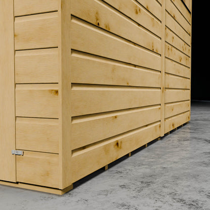 Wooden shiplap cladding of a shed on concrete floor.
