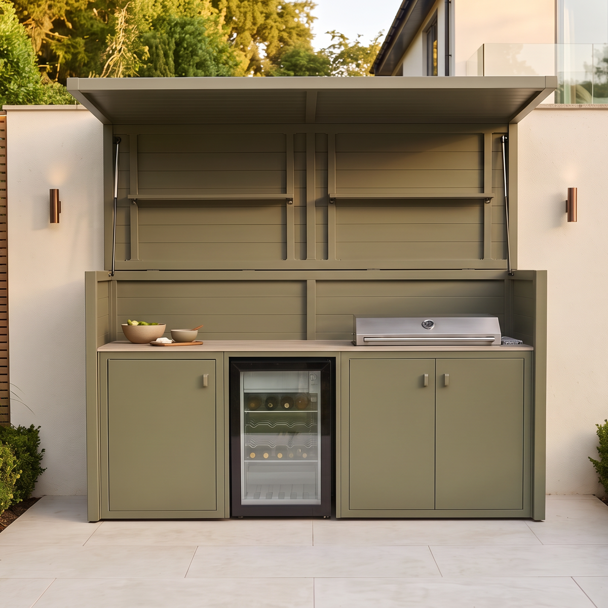 Vantage Outdoor Kitchen Pod with 4 Burner Gas Grill and Fridge, open on a patio by day, Olive Green