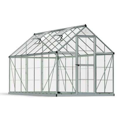A greenhouse made up of windows with silver metal framing