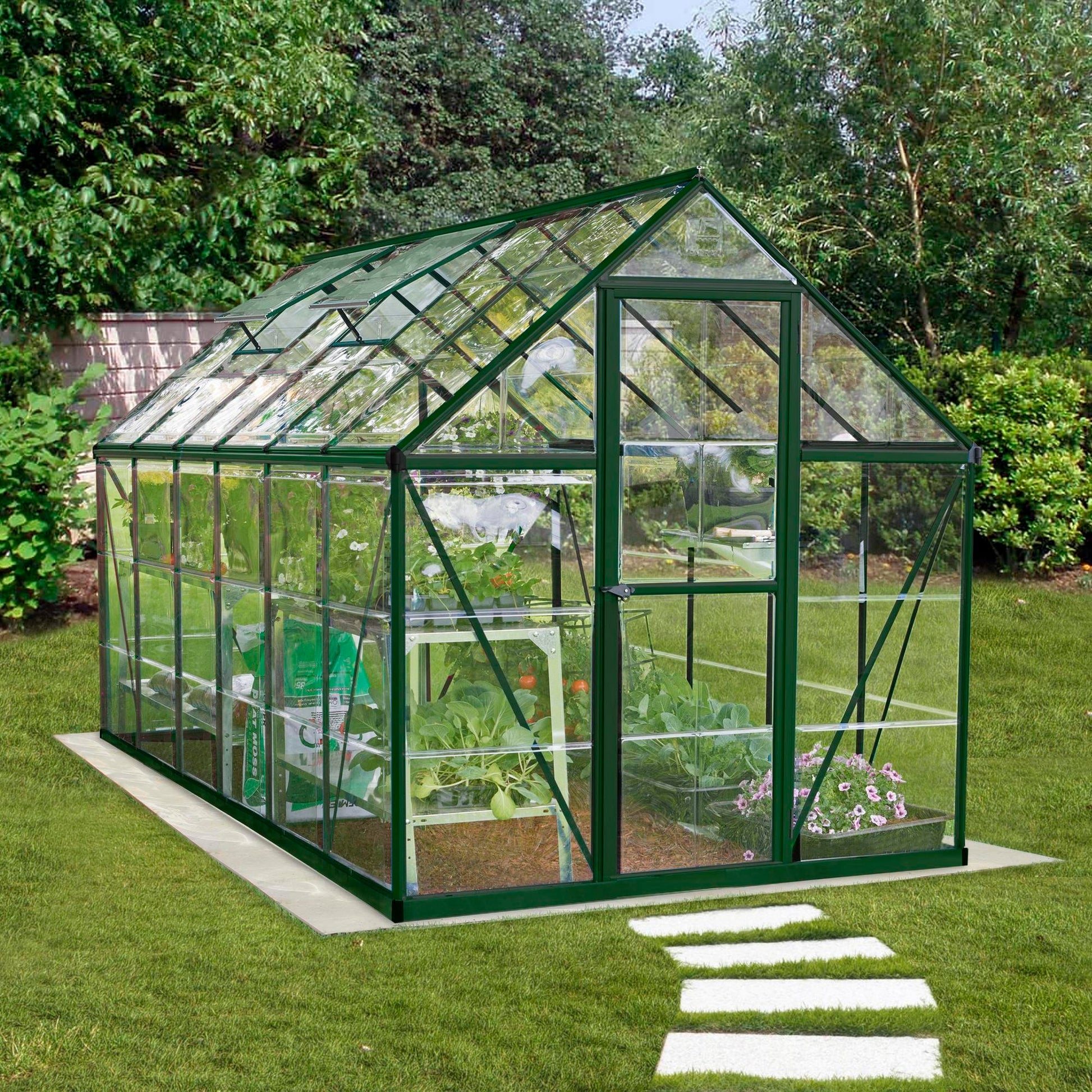 A large greenhouse made up of windows with green framing