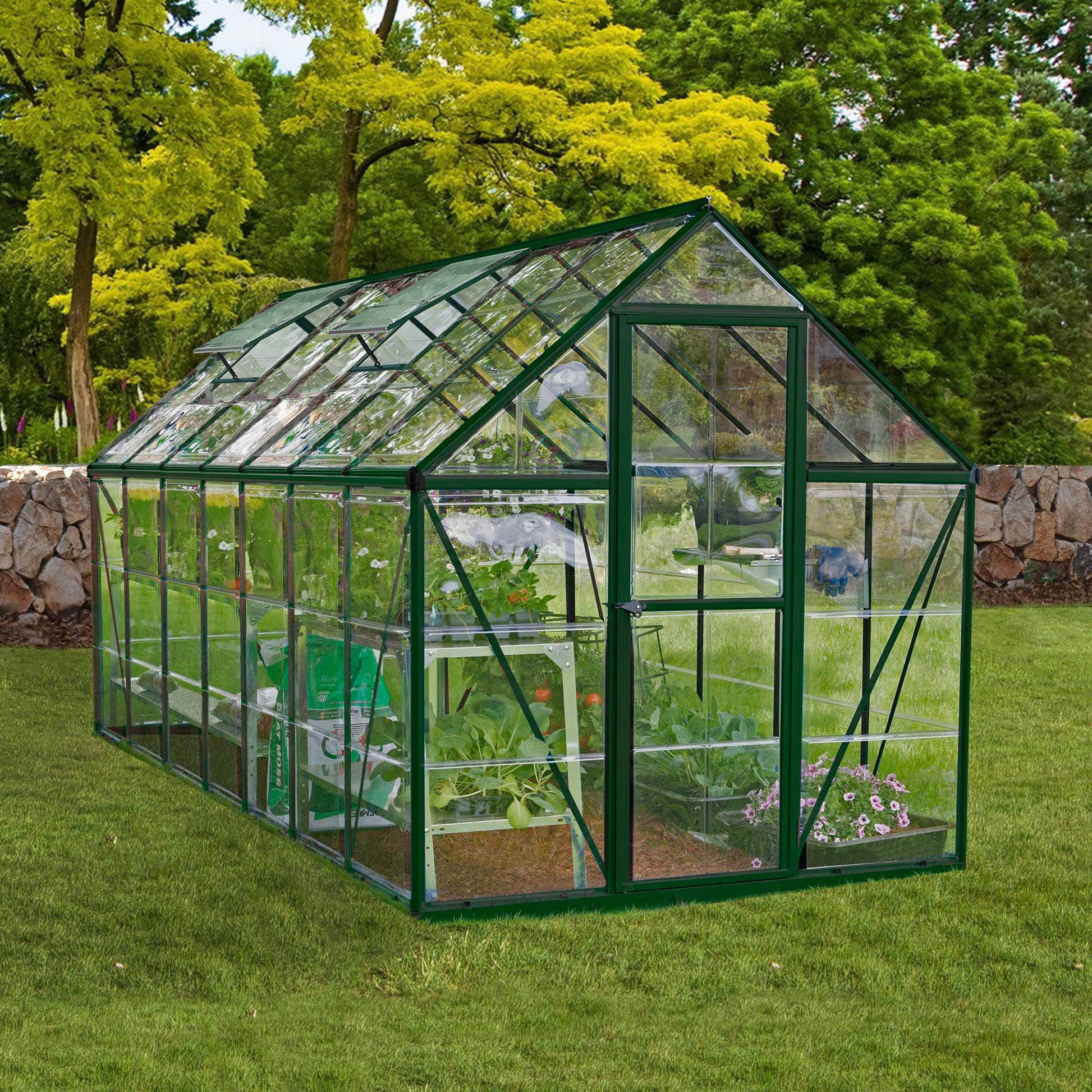 A large greenhouse made up of windows with green framing