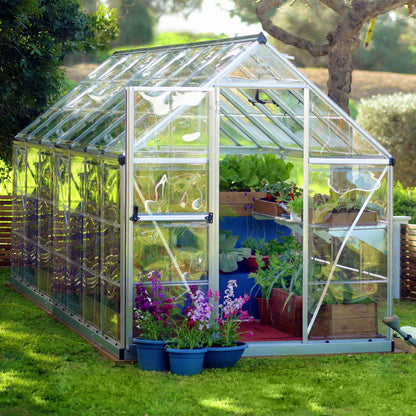 A greenhouse made up of windows with silver metal framing