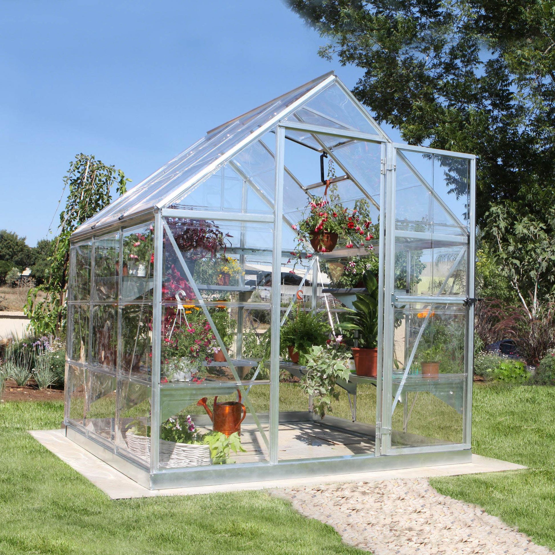 A greenhouse made up of windows with silver metal framing