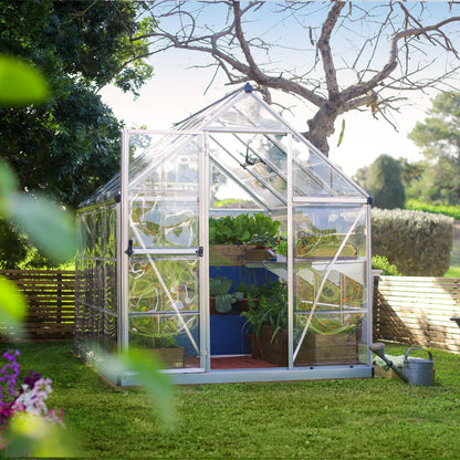 A greenhouse made up of windows with silver metal framing