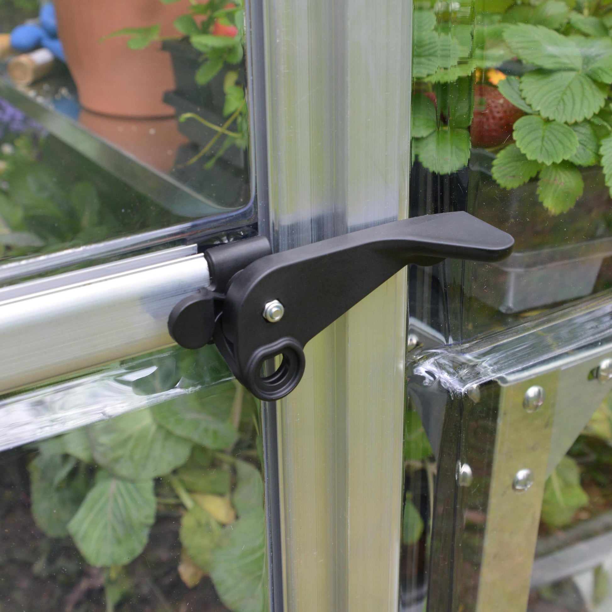 Plasti door handle to a silver metal greenhouse