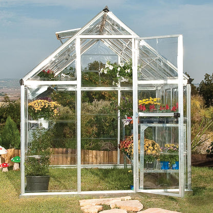 A greenhouse made from clear windows with silver metal framing