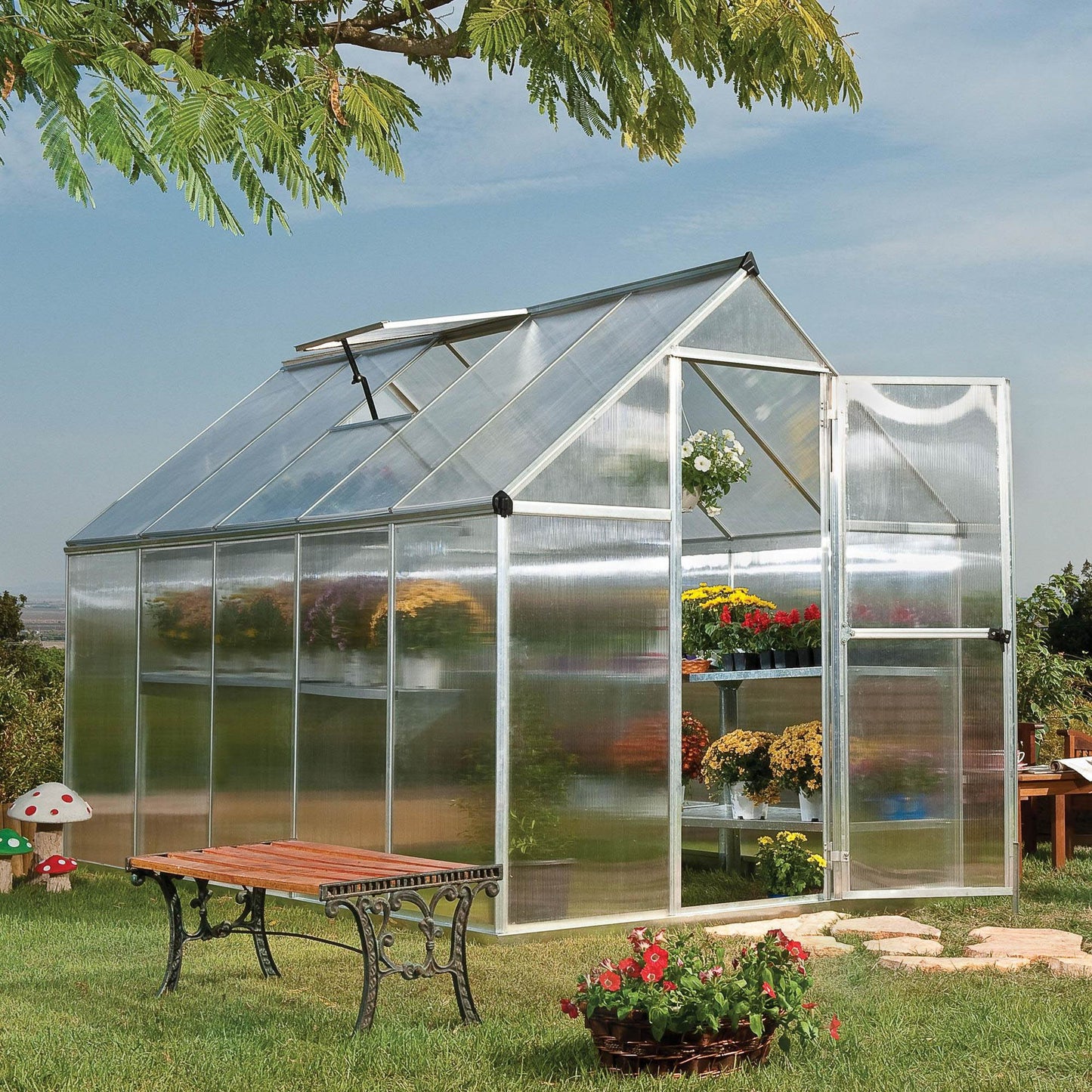 A greenhouse made up of windows with silver metal framing