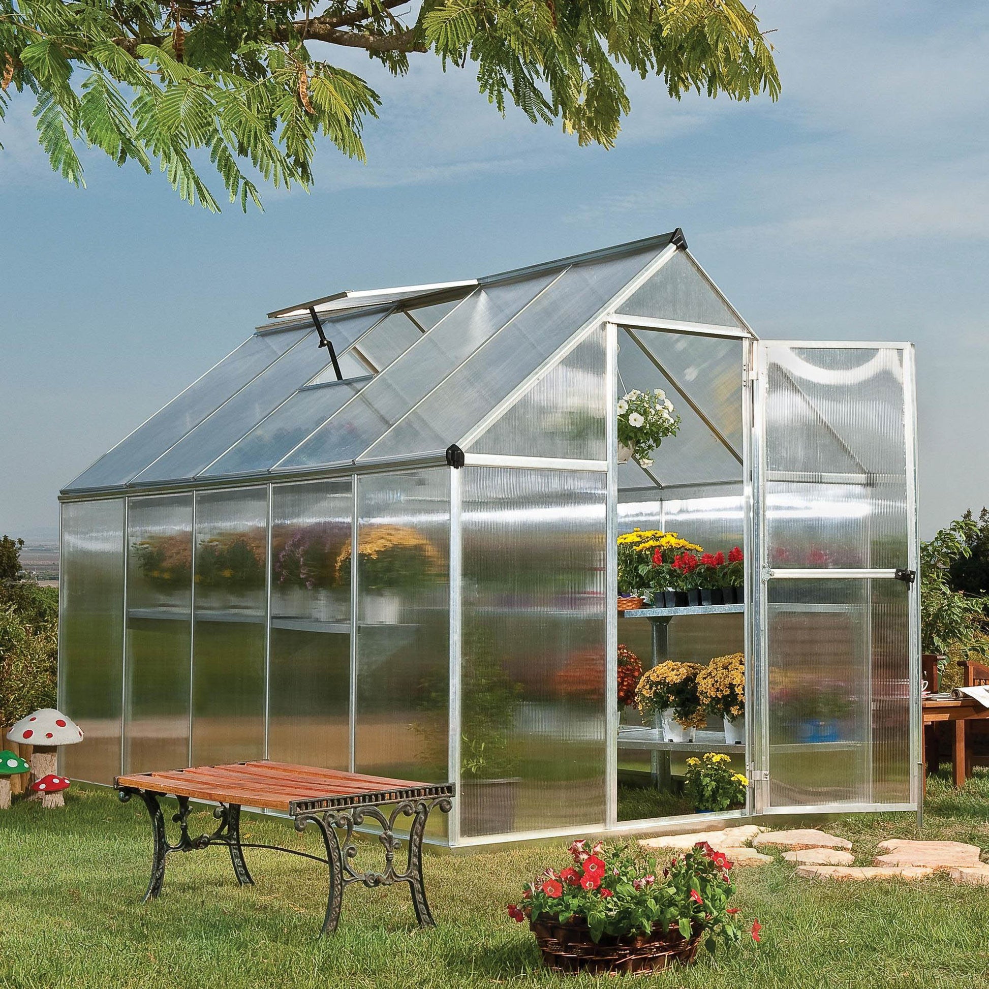 A greenhouse made up of windows with silver metal framing