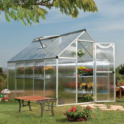 A greenhouse made up of windows with silver metal framing