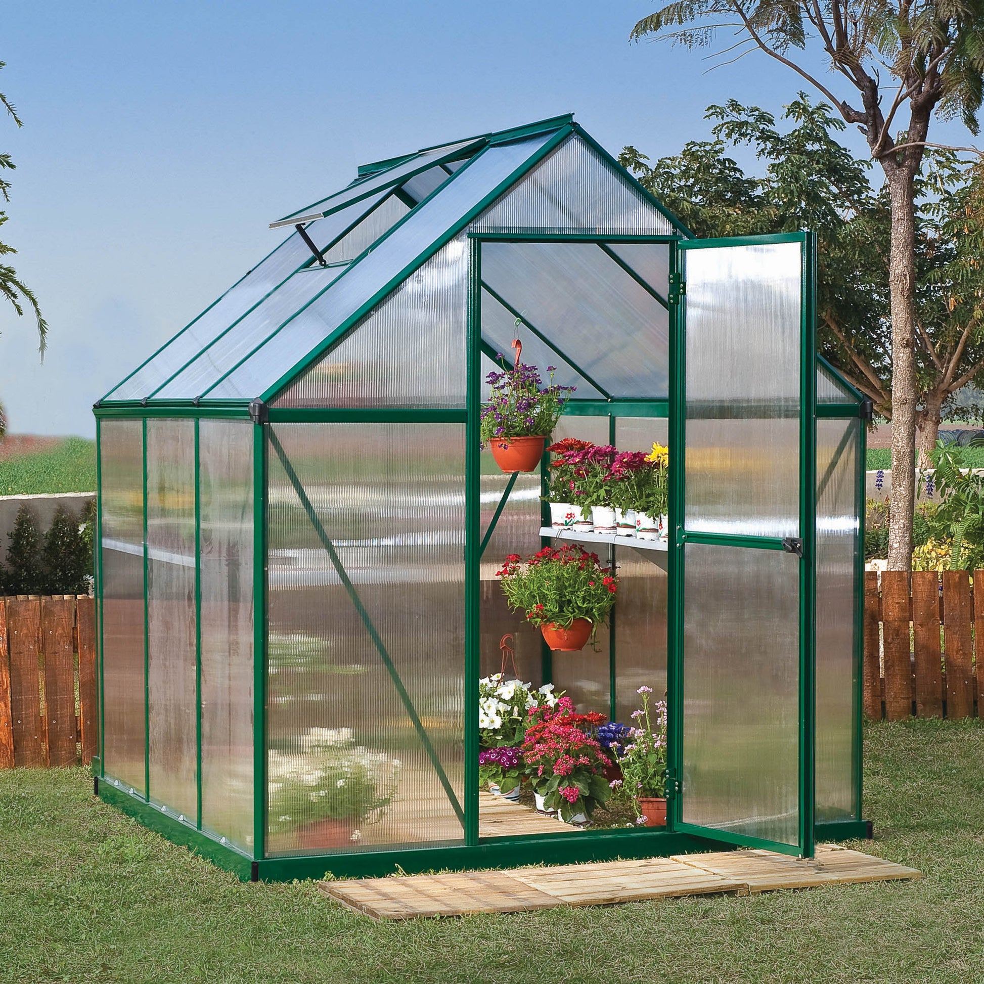 A greenhouse with textured windows and green metal framing