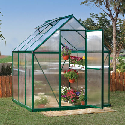 A greenhouse with textured windows and green metal framing