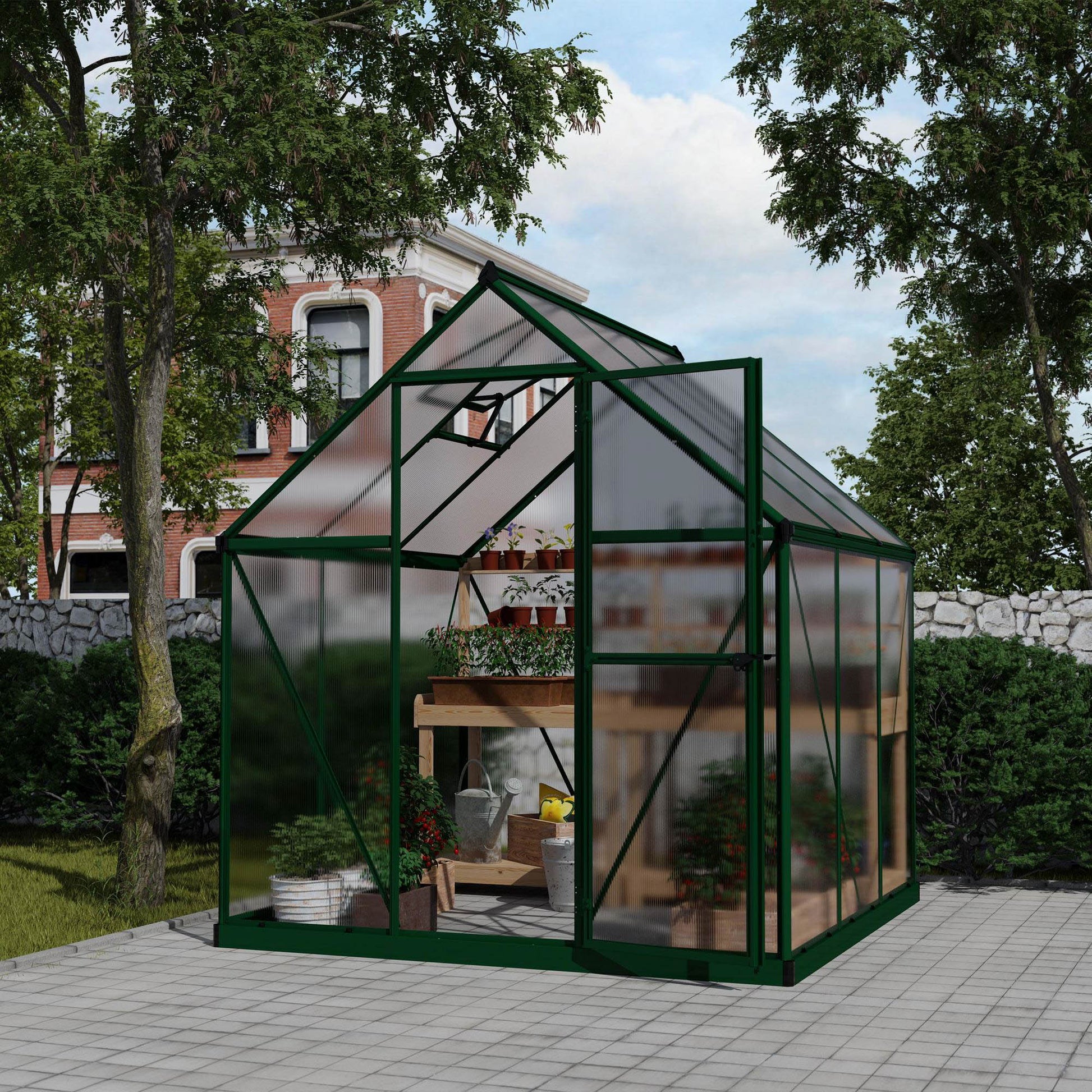 A greenhouse with textured windows and green metal framing