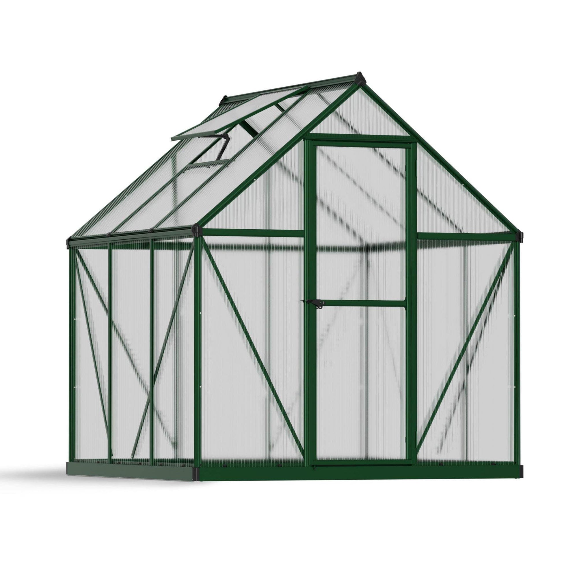 A greenhouse with textured windows and green metal framing