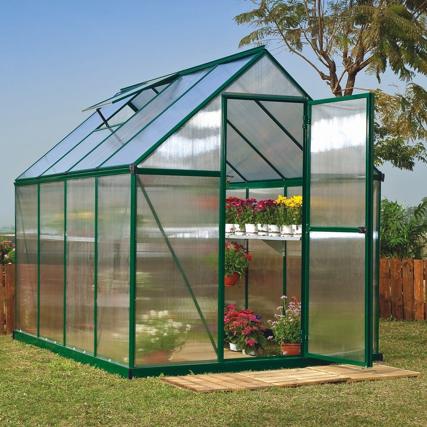 A greenhouse made up of windows with green framing