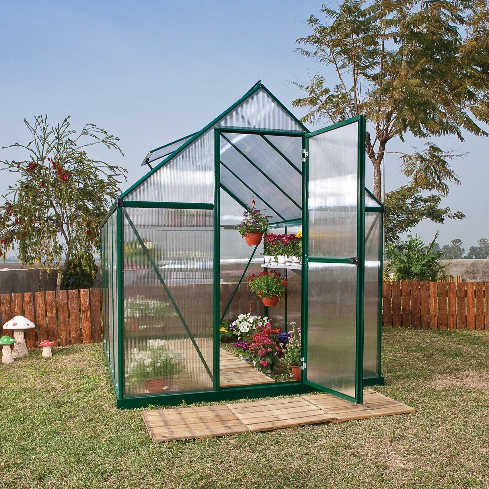 A greenhouse made up of windows with green framing
