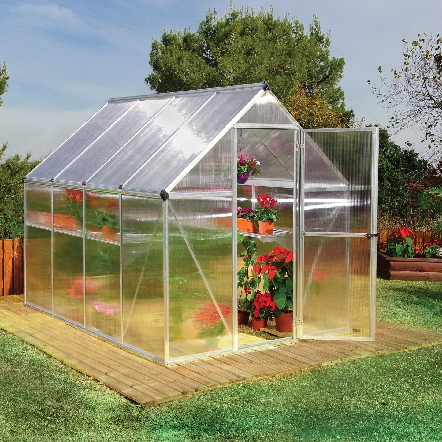 A greenhouse made up of windows with silver metal framing