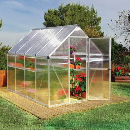 A greenhouse made up of windows with silver metal framing