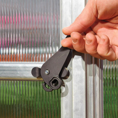 Plastic door handle on a silver metal greenhouse