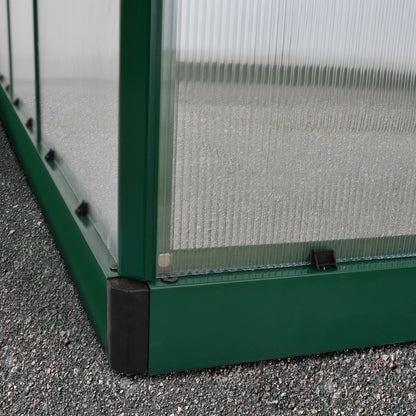 A greenhouse made up of windows with green framing