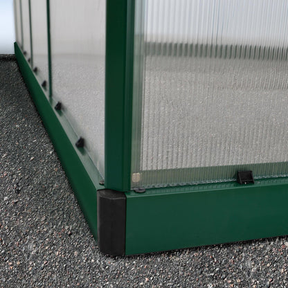 A greenhouse made up of windows with green framing