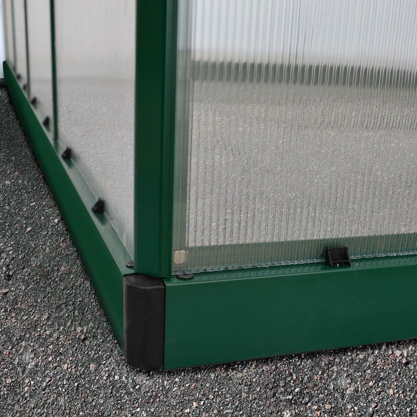 A large greenhouse made up of windows with green framing