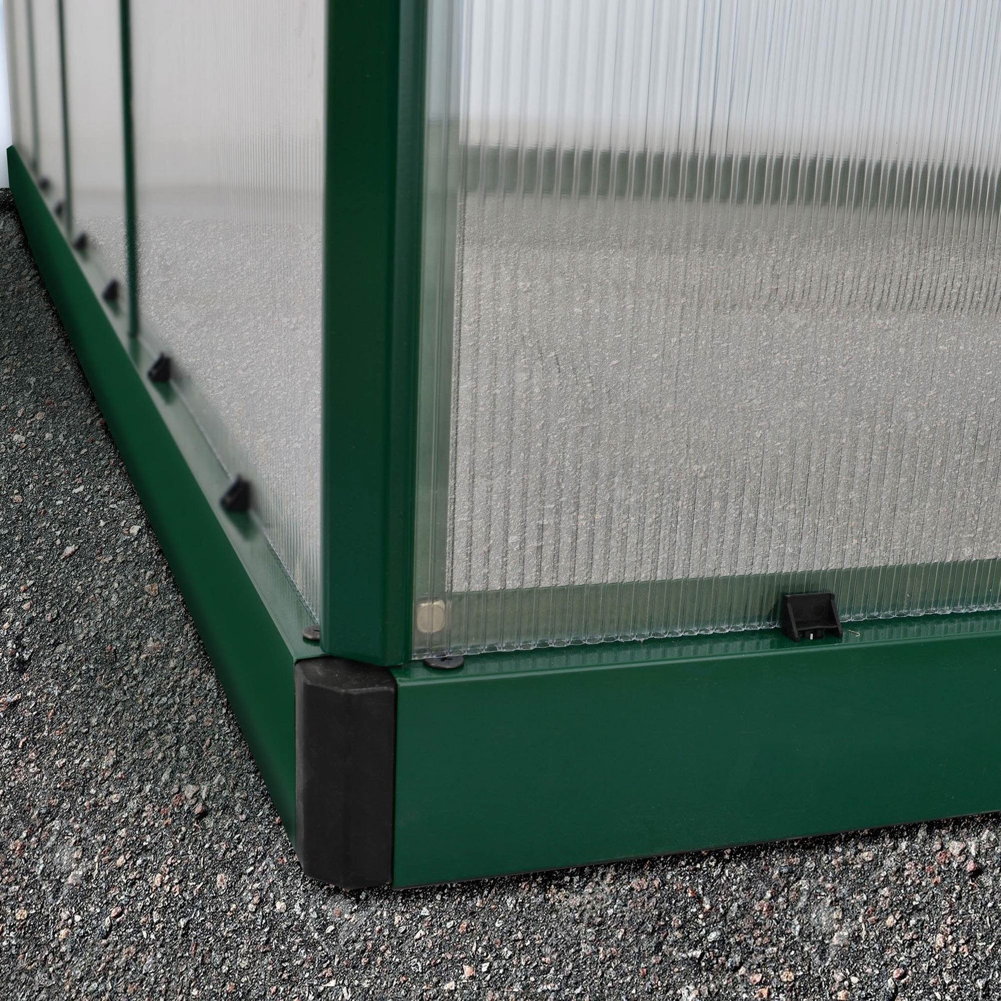 A large greenhouse made up of windows with green framing