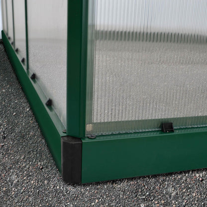 A large greenhouse made up of windows with green framing