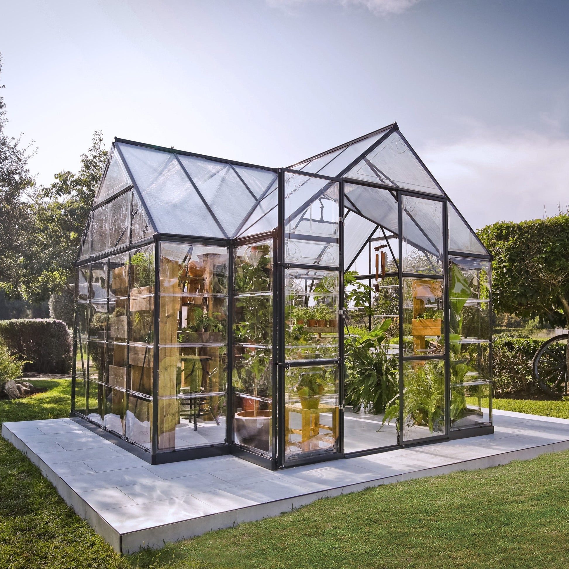 An orangery with an apex roof, made up of windows with grey metal framing