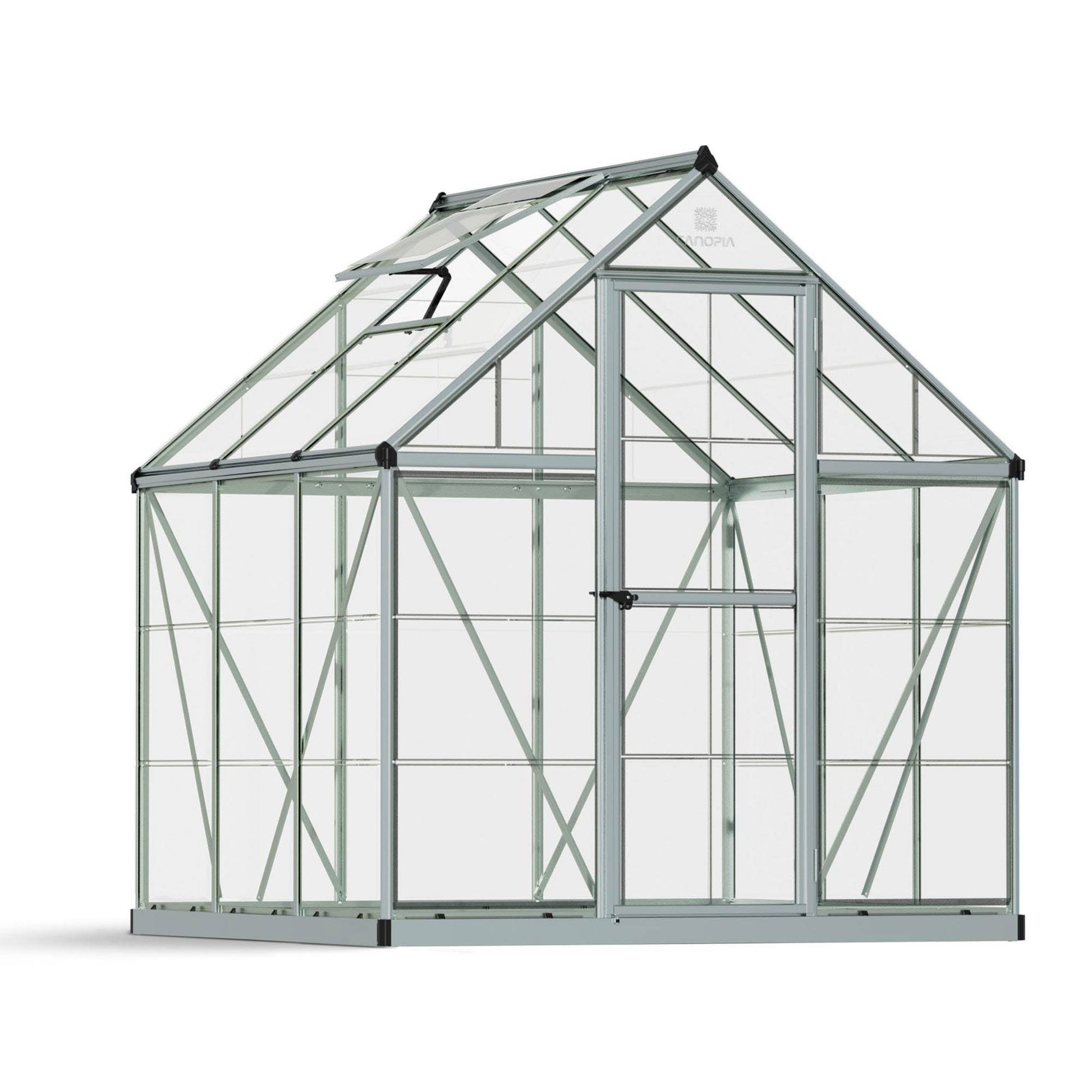 A greenhouse made up of windows with silver metal framing