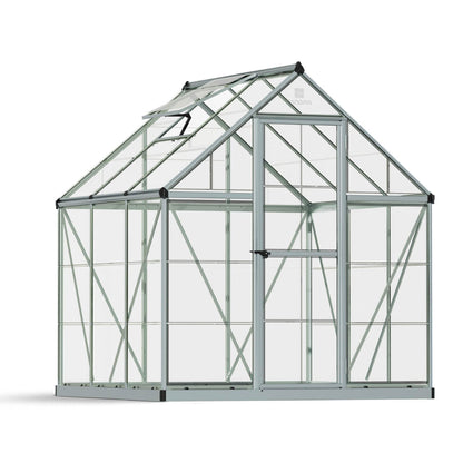 A greenhouse made up of windows with silver metal framing